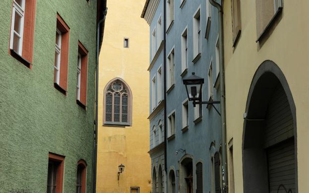 Stadtspaziergang in Regensburg entlang pastellfarbenen Gebäuden